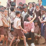 Volunteer with children of schools in rural India