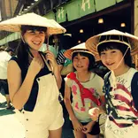 American girl with Japanese host sisters wearing traditional hats