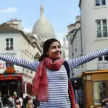 Girl with arms outstretched, taking in the beauty of France