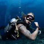 Scuba diver flexing his muscles underwater