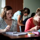students sitting at a desk reading