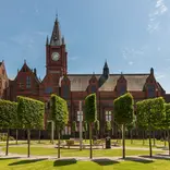 University of Liverpool campus surrounded by green trees & grass and our historic red brick buildings