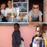 Volunteers look out from classroom