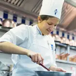 Students in the kitchen during Cuisine Diploma program at Le Cordon Bleu