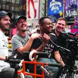 Man holds camera in Times Square