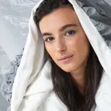 Model displaying hooded garment created by students of Accademia del Lusso