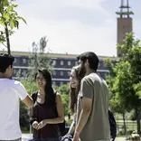 Students on campus with University tower in the background