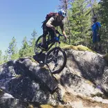 Student learning bike skills on slick rock