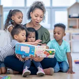Women reading to group of children