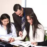 professor teaching two girls