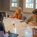 Sage Corps interns working together on their group presentation