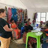 A Volunteer with women during session.