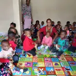 Caretaker with children at Childcare center.