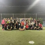 Students and local jiran posing for a photo after playing a pickup game of soccer