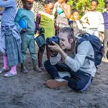 Impact Photography volunteer with community children