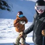 Women smiling at camera while skiing