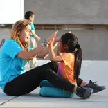 HOOP volunteer playing with student