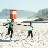 Volunteer Eline helping during a surf session.