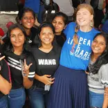 Teacher socialising with students at an event