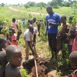 Ladder Ministries guiding OVCs on tree planting and maintainence 