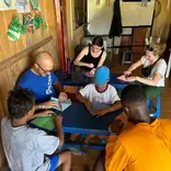 people sitting around table doing a craft