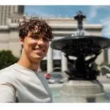 Teacher next to a neo-classical water fountain, center of Madrid