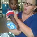 GXVO volunteer taking care of a child