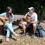 Intern playing guitar with our music teacher