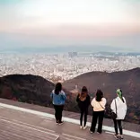 Four students overlooking beautiful city