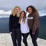 Three students on a mountaintop in Australia