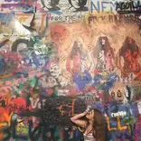 Student looks up at art