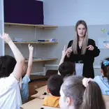 Meddeas Language Assistant with her students