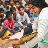 Volunteer reading to children.