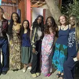 6 smiling students in traditional west african tissues and dress in Dakar, Senegal. 