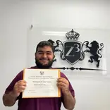 A graduating high school student holding a OSSD diploma from Z3 Education Centre