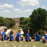 Students looking over ruins in Merida