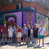 Gap internship group posing in front of street art in Buenos Aires