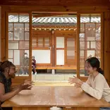 Gap year students in Seoul chatting at table