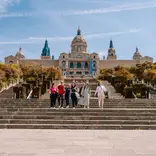EF Gap Year students walking down the steps of the National Art Museum of Catalonia (MNAC) in Barcelona, Spain, enjoying a sunny day of art, history, and exploration.