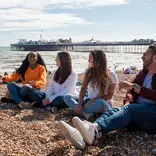 Summer School students laughing on Brighton beach