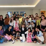 Graduating students posing with their teachers during the ceremony.