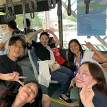 Students and a teacher riding a bus for their Friday practical lesson.