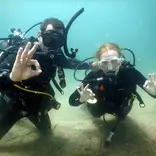 Volunteers scuba diving together during a marine conservation program in southern Tanzania