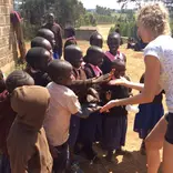 Volunteer celebrating with school children 
