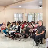 A room of students attending a course, watching the trainer. 