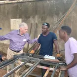Volunteer supporting vocational training workshop at RMFSL Skilling Station in Kampala