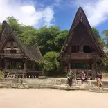 AFS Students sitting in front of old traditional houses in Indonesia