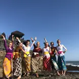 Students in traditional clothes on beach in Indonesia