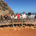 Students pose at Cape of Good Hope sign.