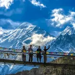 Students pose on bridge in Himalayas.